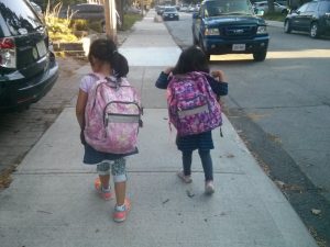 Girls walking to school with backpacks